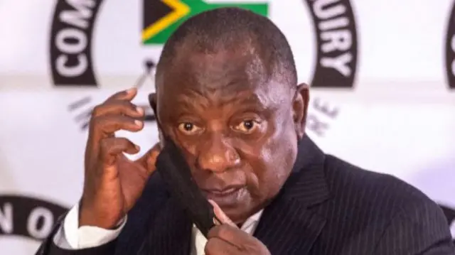 Cyril Ramaphosa putting on a mask