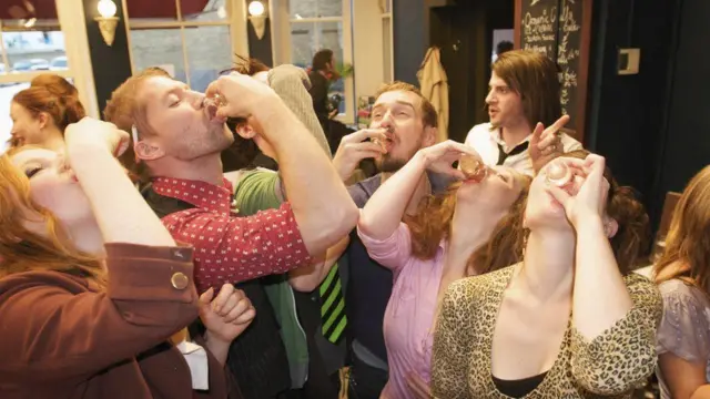 People drinking shots in a pub