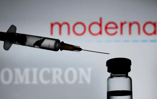 A syringe before the Moderna logo