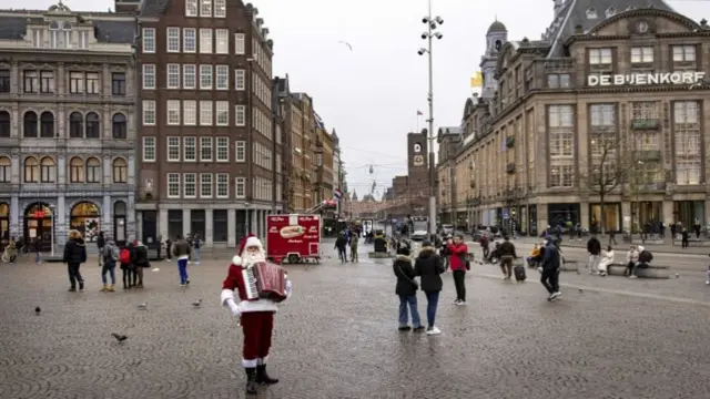 People walk around downtown Amsterdam during a coronavirus lockdown in the Netherlands, 19 December 2021