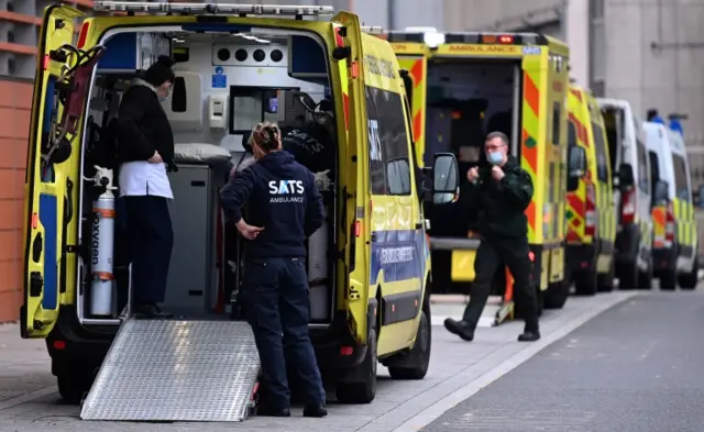 NHS ambulance staff stand outside the Royal London hospital in London. File photo