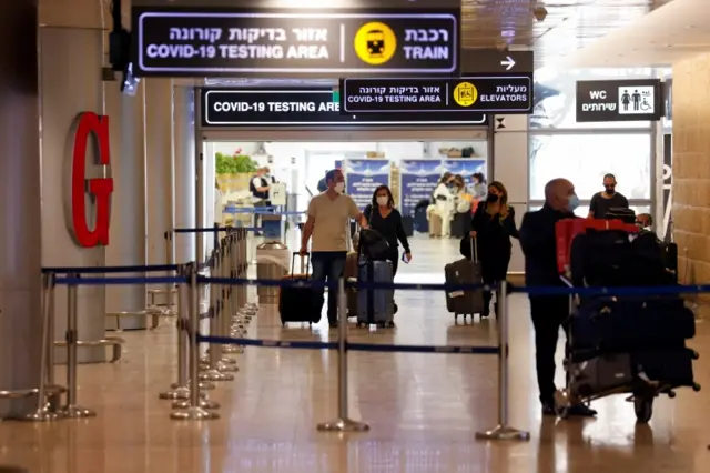 Travellers exit the coronavirus testing area at Ben Gurion International Airport as Israel imposes new restrictions