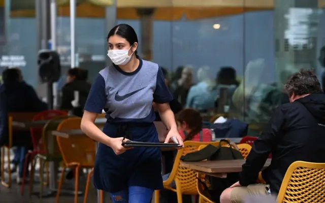 A waitress at a restaurant in London. File photo