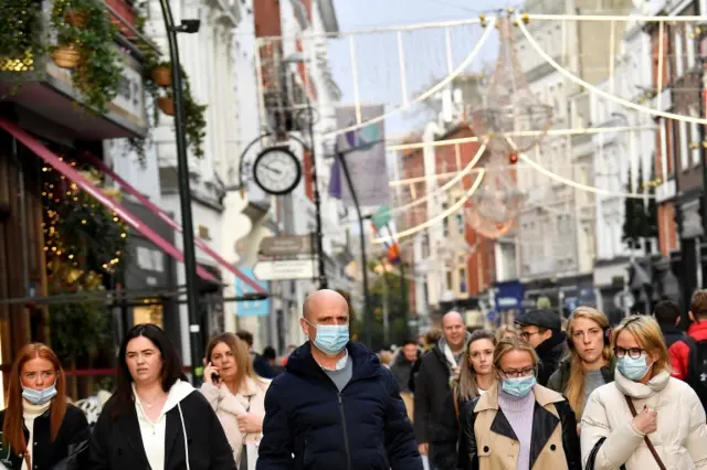 People wear protective face masks while out for Christmas shopping, amid the spread of the coronavirus disease (COVID-19) pandemic, in Dublin, Ireland, December 17,