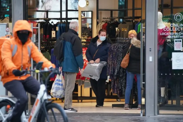 Shoppers wear face masks amid Omicron wave