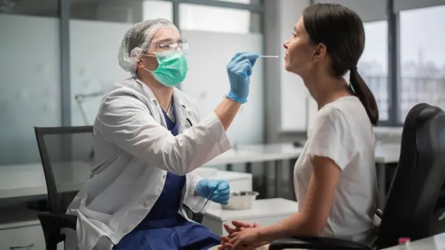 A health professional performing a Covid test - stock