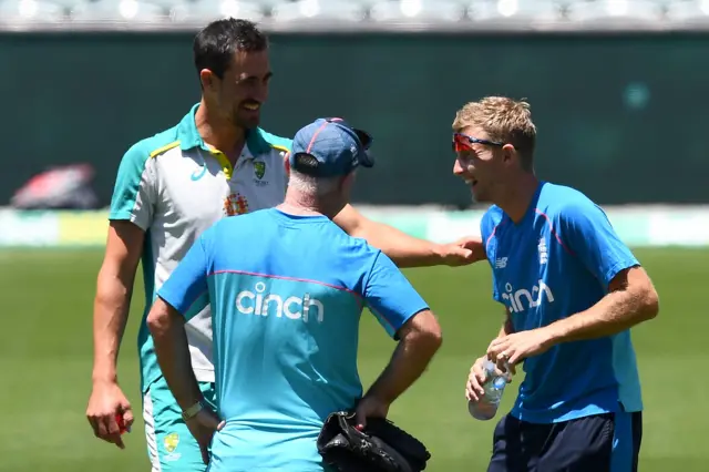 Mitchell Starc (left) and Joe Root (right) share a joke