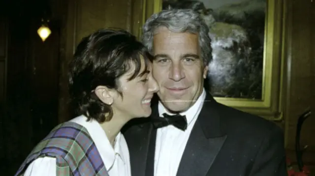 Jeffrey Epstein standing with Ghislaine Maxwell.