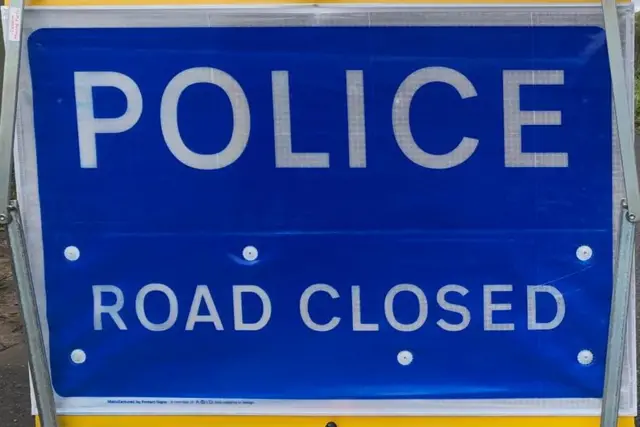 Police road closed sign