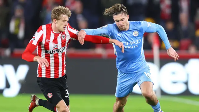 Roerslev and Grealish battle for possession