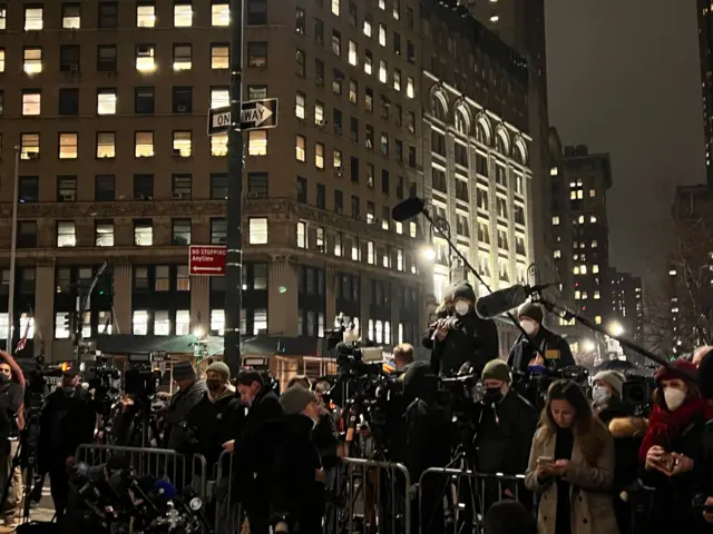 Reporters and camera crews standing behind a barrier outside a Manhattan courthouse as the jury against Ghislaine Maxwell came ion.