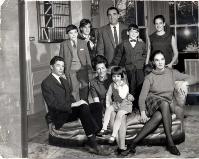 Ghislaine Maxwell sitting on her mother's lap near her father Robert Maxwell and her siblings.