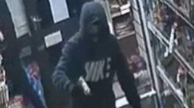 Robber holding gun