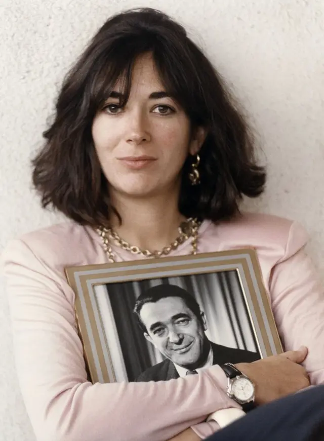 Ghislaine Maxwell, holding a framed photograph of her late father