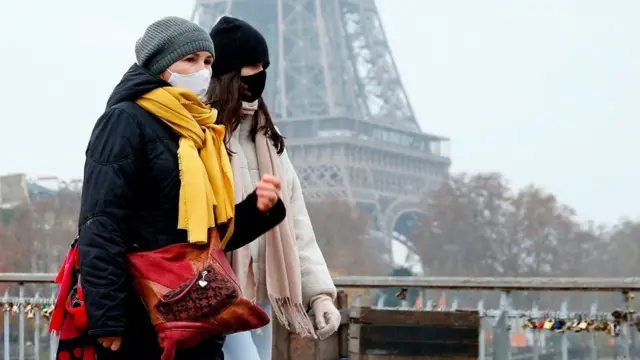 Women walking past Eiffel Tower