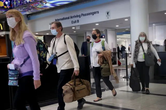 Travellers in masks at Chicago airport