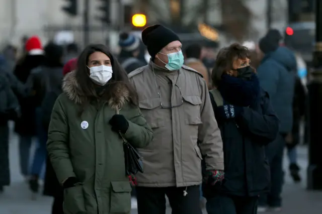 People wearing masks on a street in London