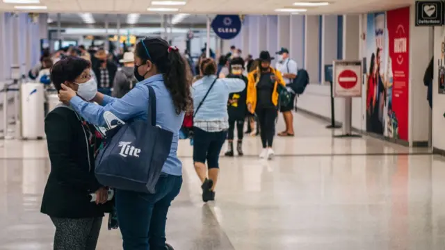 A mother hugs her child at Houston airport