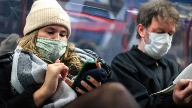 Commuters wearing masks