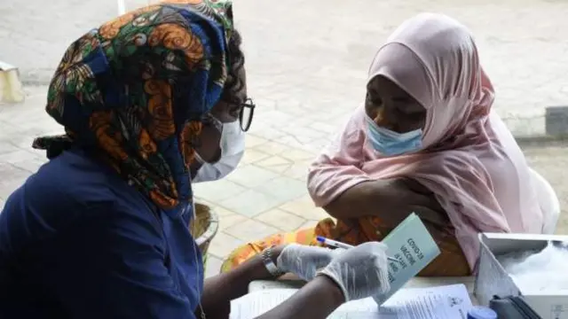 A health official speaks to a woman at a vaccination centre in Lagos, Nigeria. File photo