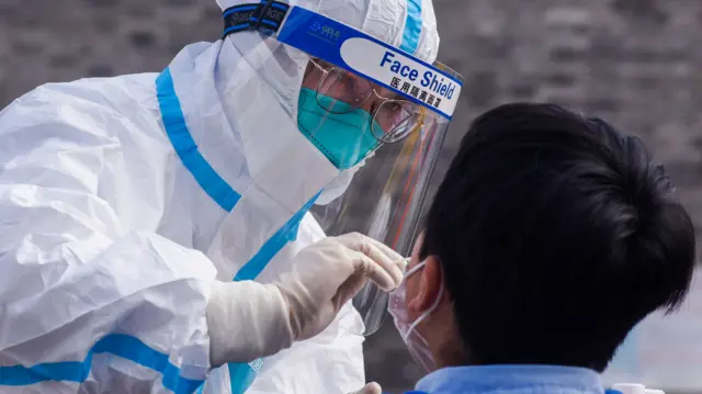 Medical worker collects swab from a citizen in Zhenhai District, China.