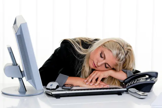 Woman sleeping at work