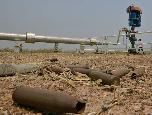 spent munitions lying on the ground at an abandoned oil treatment