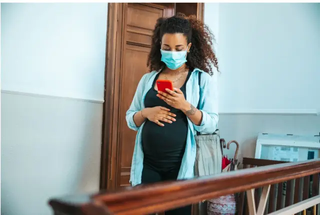 Pregnant woman wearing mask