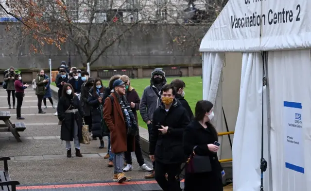 People queue for vaccines in London