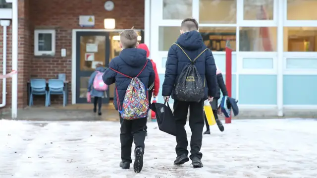 Children walking into school in icy weather