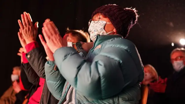 Audience members wearing face masks