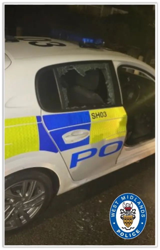 The smashed police car window