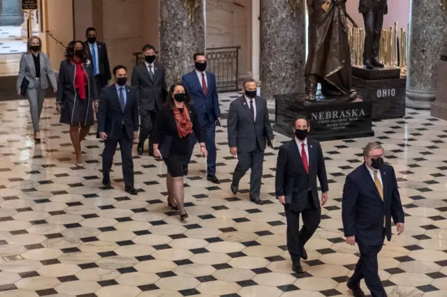 The House Sergeant of Arms walks with House impeachment managers to the Senate floor on 9 February 2021, in Washington, DC.