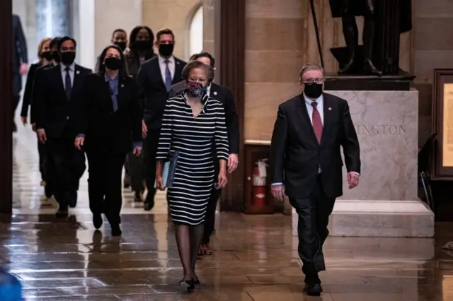 House impeachment managers led by Cheryl Johnson, clerk of the House of Representatives; and Timothy Blodgett, acting sergeant at Arms of the House, arrive to deliver an article of impeachment against former President Donald Trump to the Senate for trial on accusations of inciting the deadly January 6 attack on the Capitol, at the Capitol building in Washington, US, on 25 January 2021.