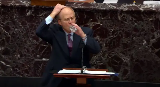 In this screenshot taken from a congress.gov webcast, David Schoen, defense lawyer for former President Donald Trump drinks some water during first day of Senate trial on 9 February