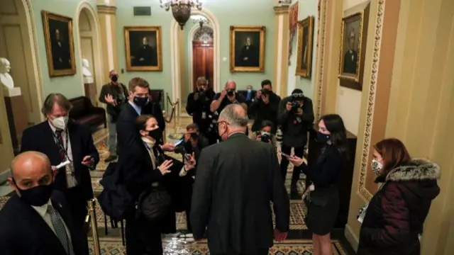 Senate Majority Leader Chuck Schumer and reporters