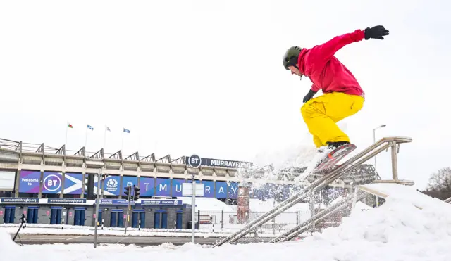 A snowboarder enjoys the snow around Murrayfield