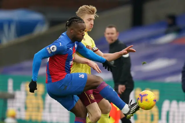 Crystal Palace's Michy Batshuayi tackles Burnley's Ben Mee