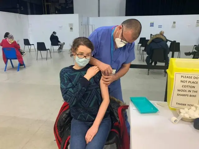 Johnathan Van Tam carrying out vaccinations