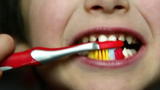 Child brushing teeth