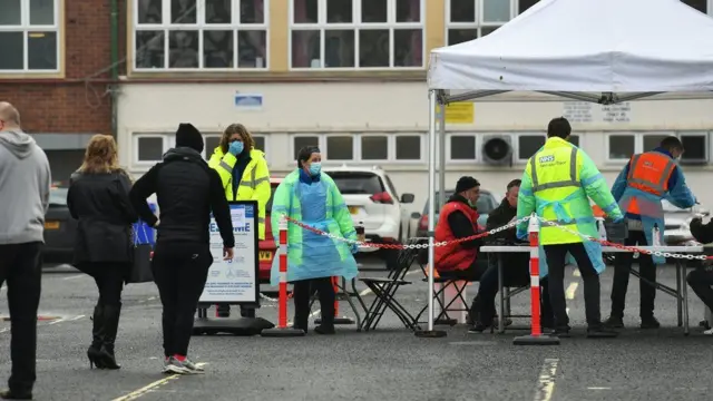 People arrive at a mobile unit in Walsall borough