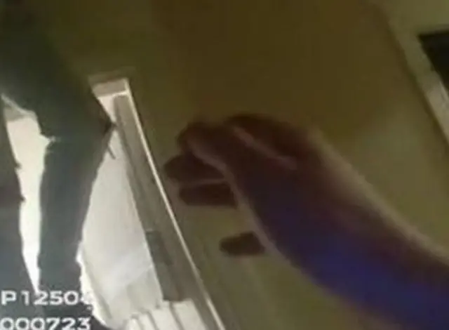 Police bodycam footage captures a man's legs dangling from the loft