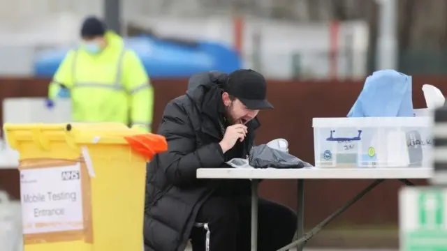 A man takes a swab at a COVID-19 test centre