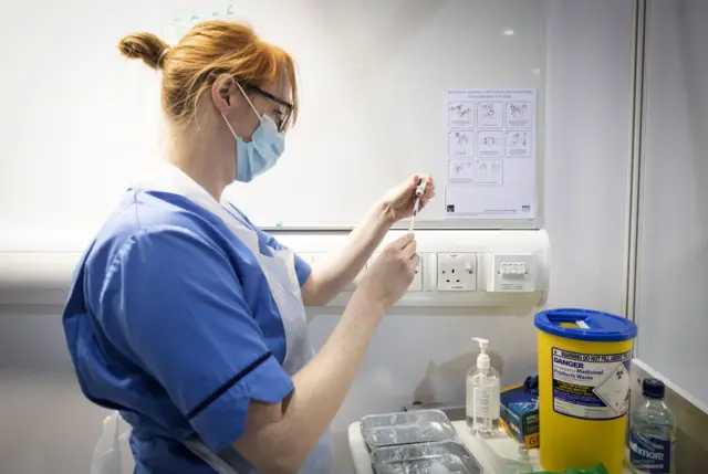 Nurse prepares vaccine