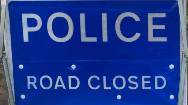 Police road closed sign