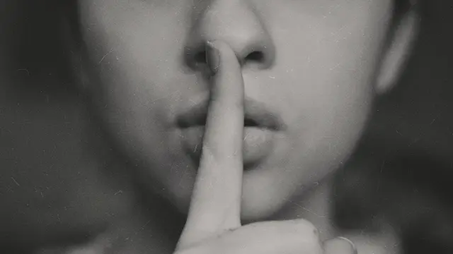Person saying Shhh