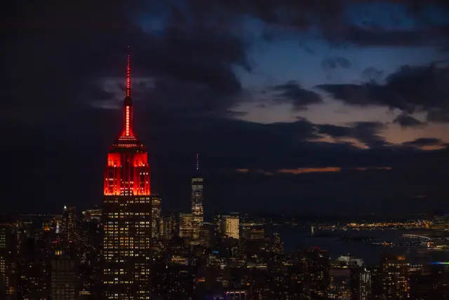 The Empire State Building lit up in red