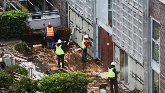 Builders removing cladding