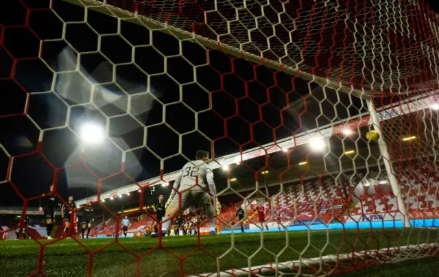 Lewis Ferguson's shot strikes the bar and drops close to the line