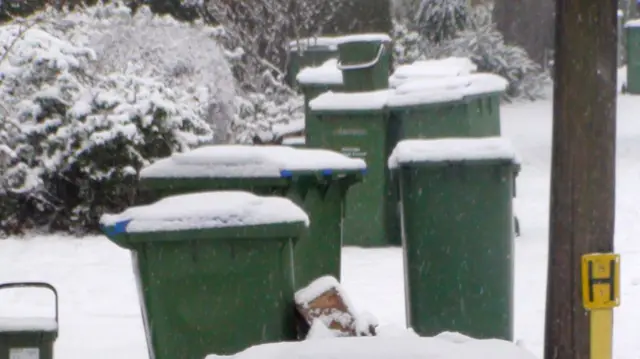 A snow covered bin